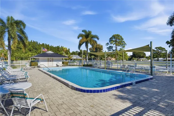 a view of swimming pool with outdoor seating and city in back