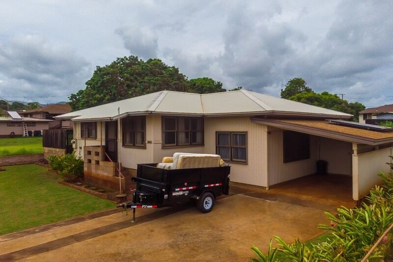 4770 Moi Road Hanapepe, HI 96716 - Photo 2 of 11 a backyard of a house with yard fire pit and outdoor seating