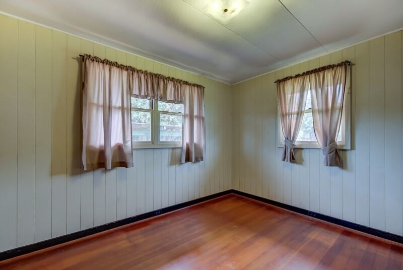 4770 Moi Road Hanapepe, HI 96716 - Photo 7 of 11 an empty room with wooden floor and windows