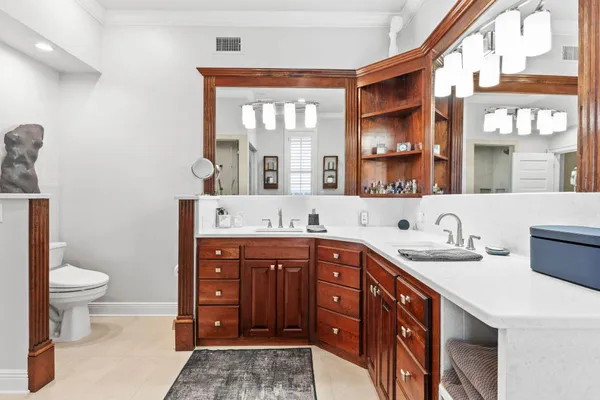 a bathroom with a double vanity sink and a toilet