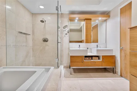 a bathroom with a sink toilet a mirror and shower