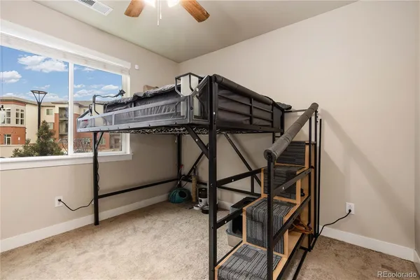 an empty room with windows & cabinet