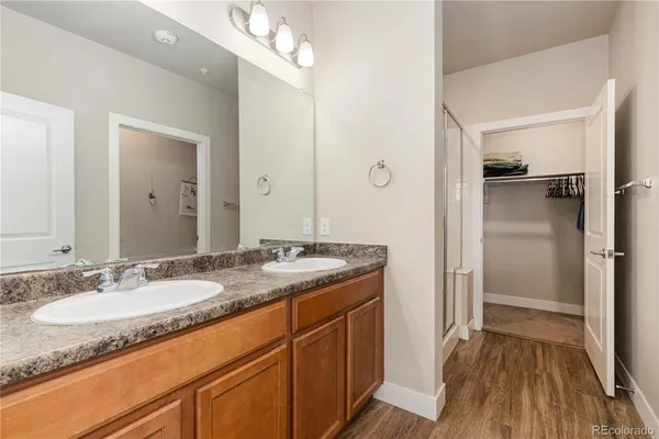 a bathroom with a granite countertop sink and shower