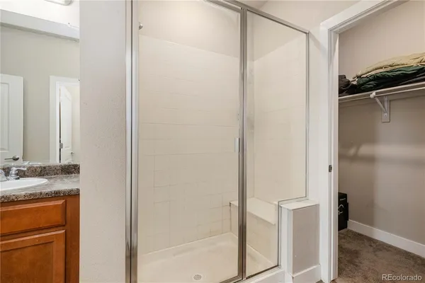 a view of walk in closet with clothes