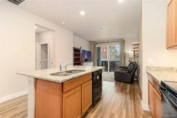 a kitchen with a counter top space a sink stove and cabinets