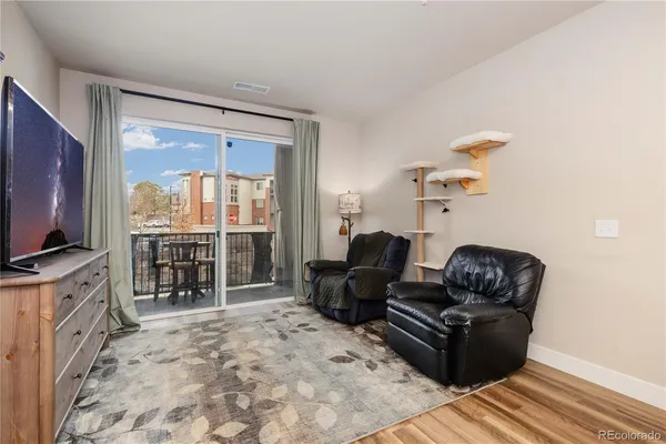 a living room with furniture tv and a flat screen tv