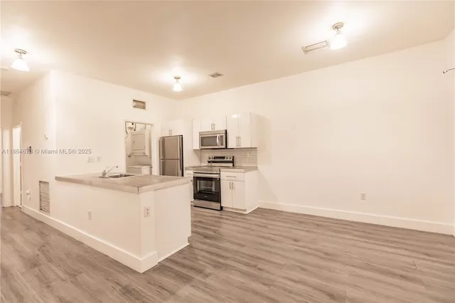 a kitchen with a sink and a stove top oven