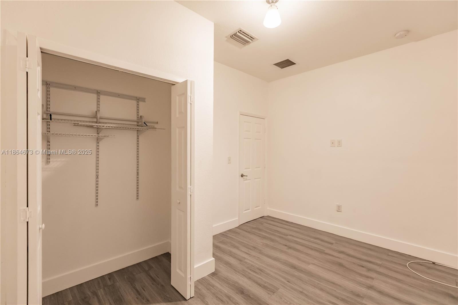 445 Northwest 77th Street, Unit 445 Miami, FL 33150 - Photo 9 of 20 a view of a room with wooden floor