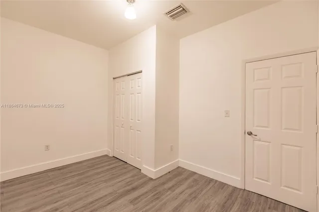 an empty room with wooden floor