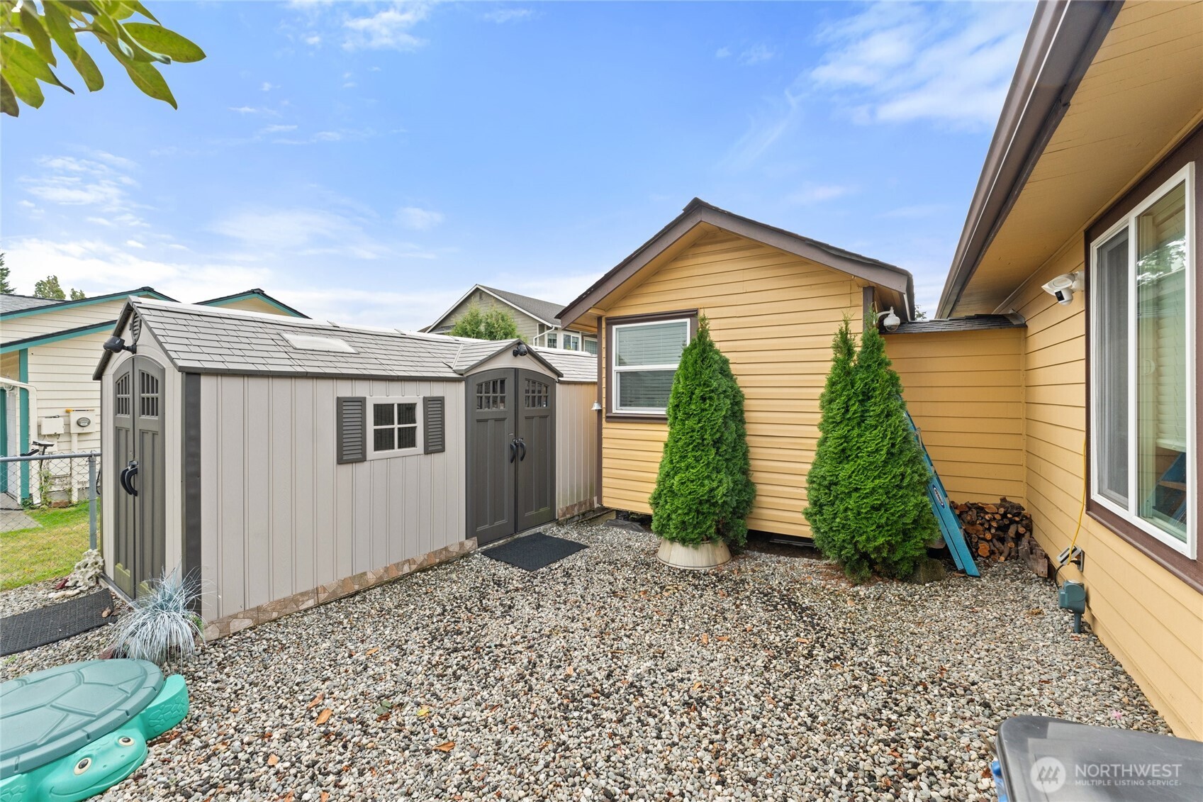 10107 Meridian Avenue Everett, WA 98208 - Photo 23 of 26 a front view of a house with a yard and potted plants