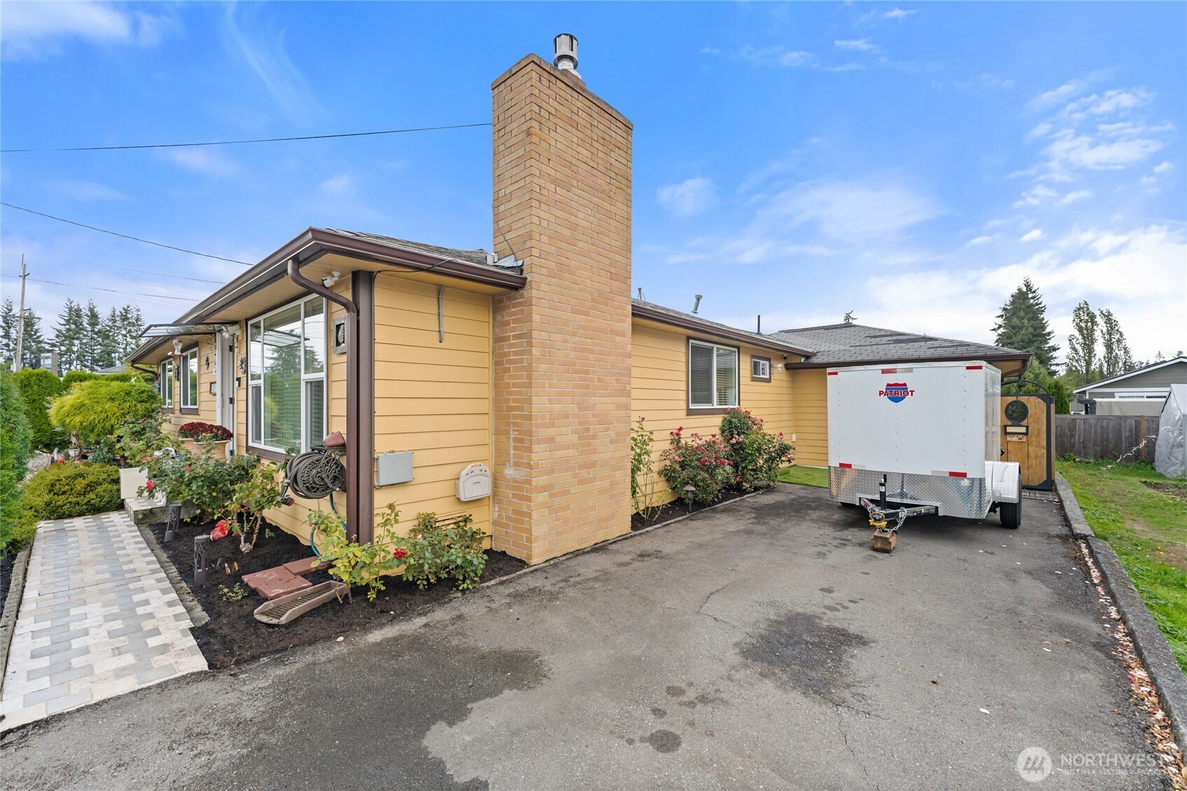 10107 Meridian Avenue Everett, WA 98208 - Photo 25 of 26 a front view of a house with a garden
