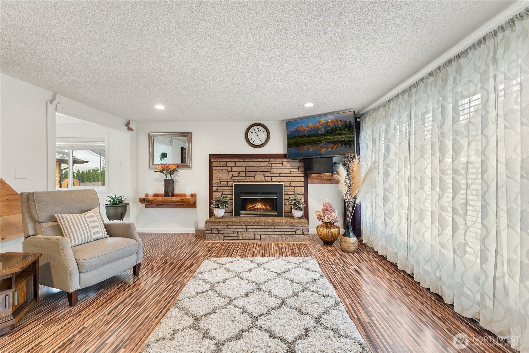 10107 Meridian Avenue Everett, WA 98208 - Photo 3 of 26 a living room with furniture and a fireplace