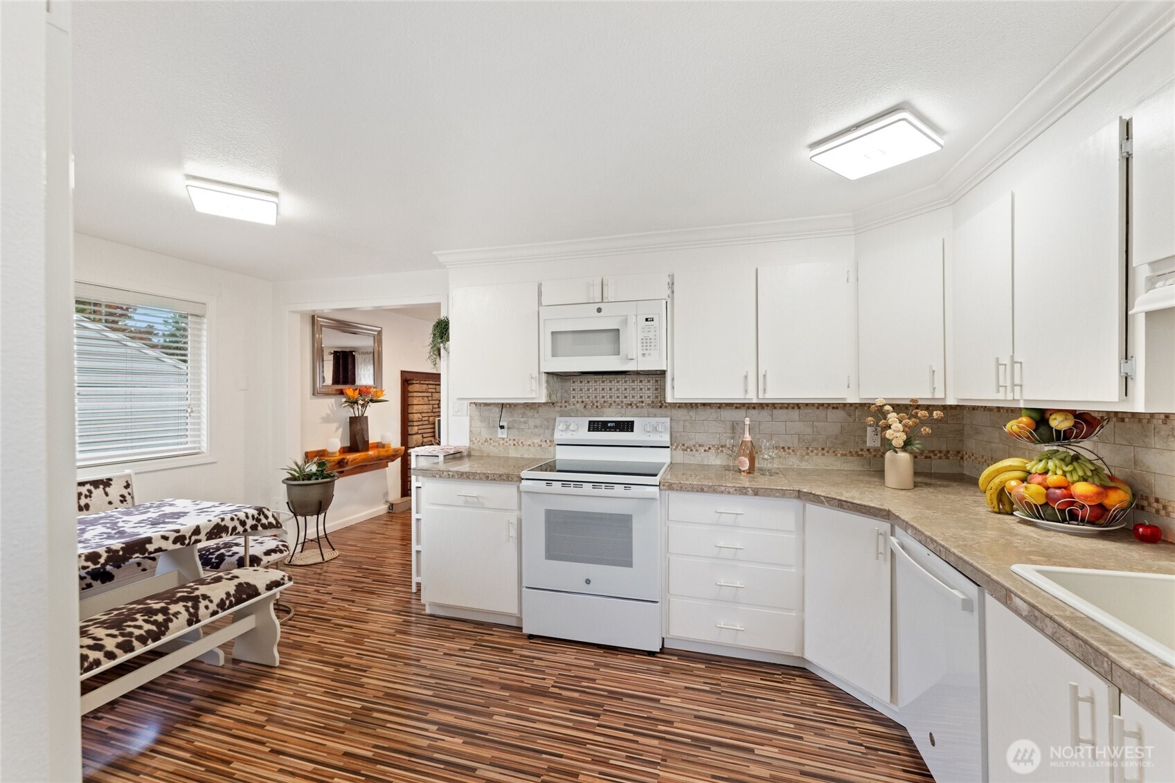 10107 Meridian Avenue Everett, WA 98208 - Photo 5 of 26 a kitchen with a sink stove and cabinets
