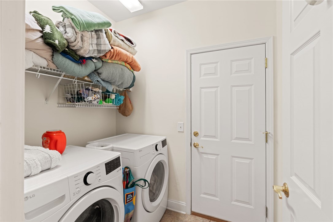 108 Winterbrook Circle Seneca, SC 29678 - Photo 20 of 40 Functional utility room featuring modern appliances and practical overhead shelving.