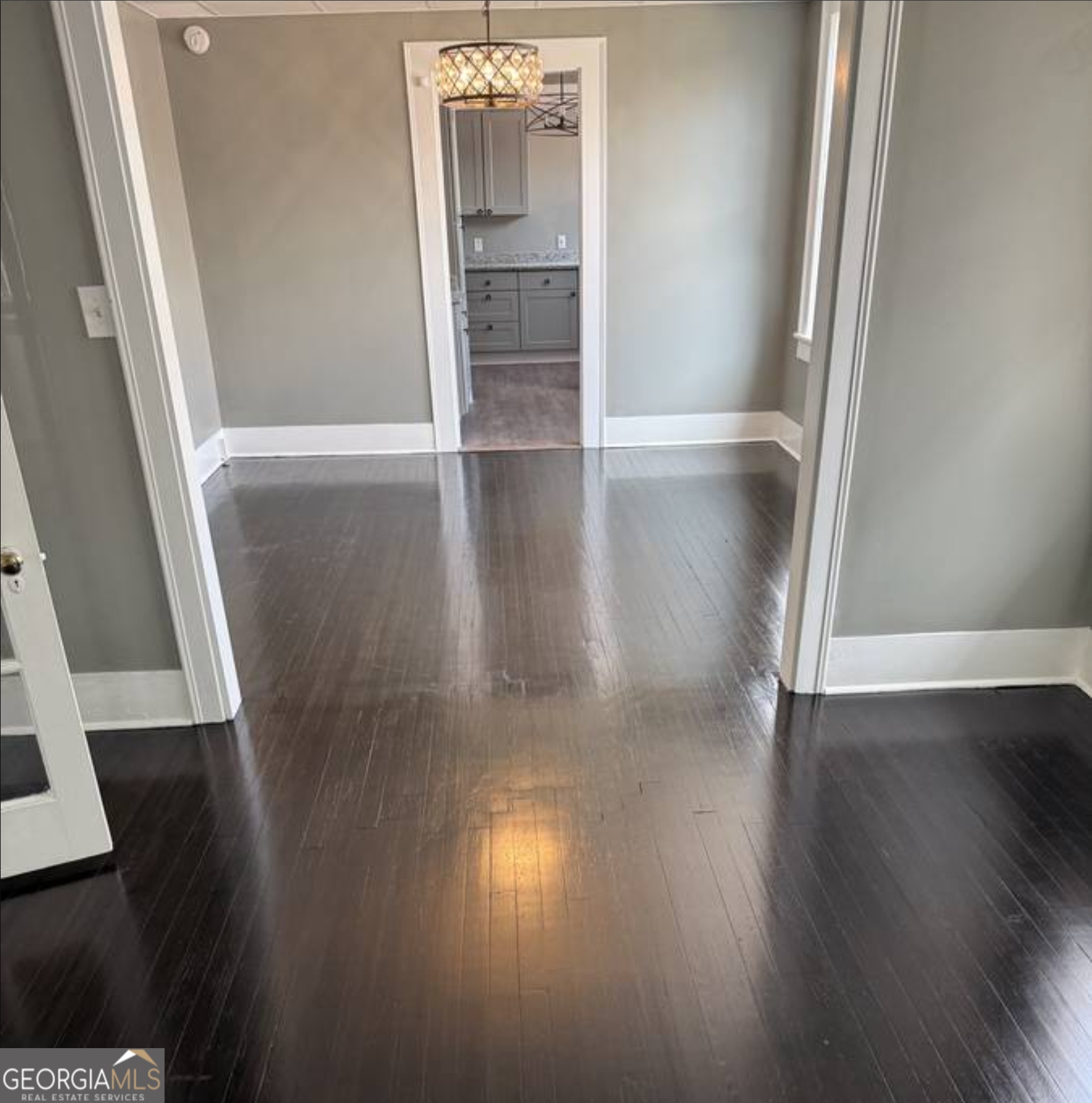 919 Inverness Avenue Macon, GA 31204 - Photo 2 of 9 an empty room with wooden floor and staircase