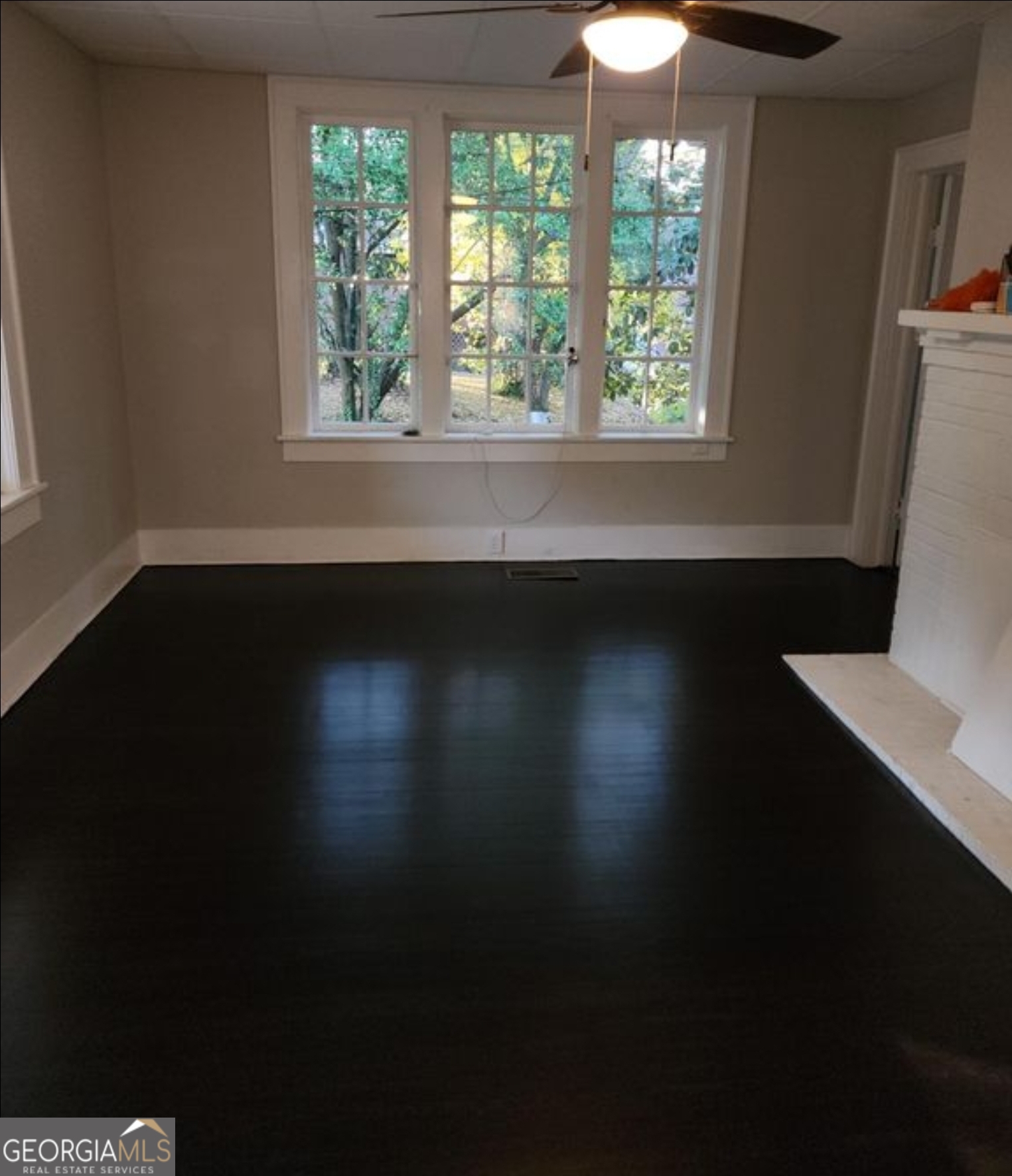 919 Inverness Avenue Macon, GA 31204 - Photo 9 of 9 a view of an empty room with wooden floor and a window