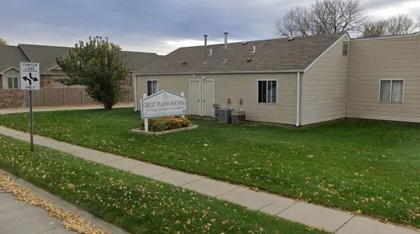 a front view of a house with a garden and yard