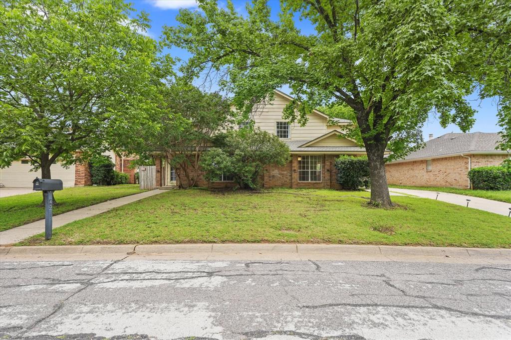 4007 Ridgebrook Drive Arlington, TX 76015 - Photo 1 of 18 Brick and siding exterior featuring mature trees, a manicured lawn, an extended driveway, and a concrete walkway