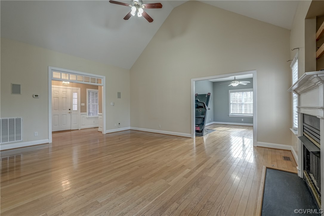 13220 2nd Branch Road Chesterfield, VA 23838 - Photo 11 of 50 an empty room with wooden floor fireplace and windows
