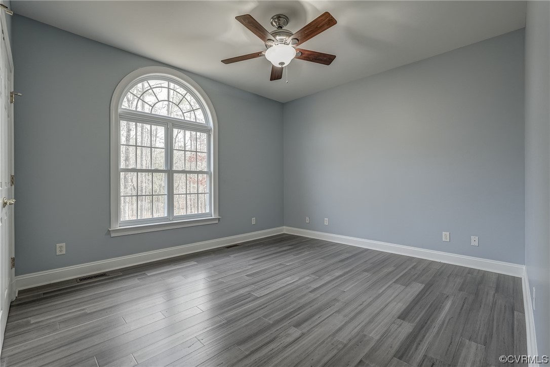 13220 2nd Branch Road Chesterfield, VA 23838 - Photo 29 of 50 an empty room with wooden floor chandelier fan and windows