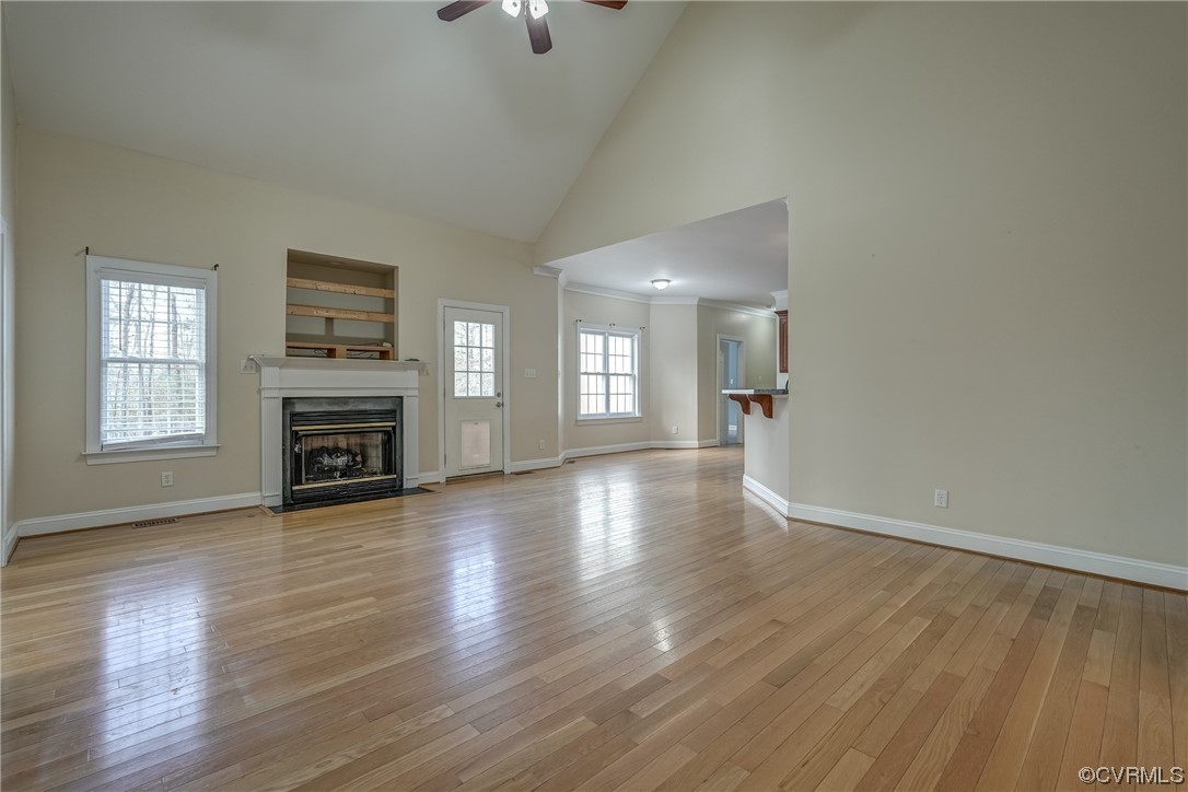 13220 2nd Branch Road Chesterfield, VA 23838 - Photo 9 of 50 an empty room with wooden floor and a fireplace