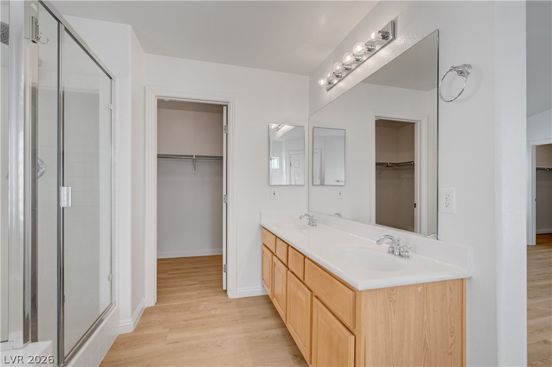 8918 Houston Ridge Avenue Las Vegas, NV 89178 - Photo 22 of 35 Double vanity and a spacious walk-in shower elevate this well-appointed primary bathroom.
