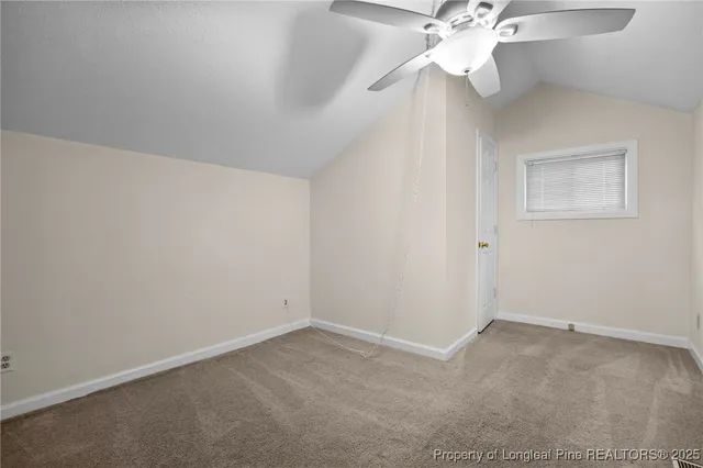 an empty room with a fan & a fan