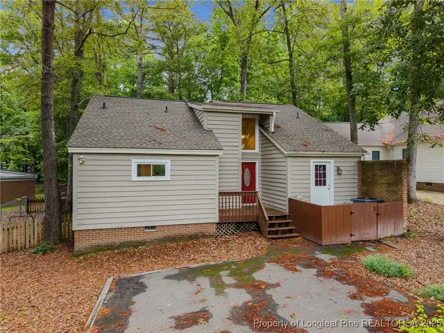 a view of house with a backyard
