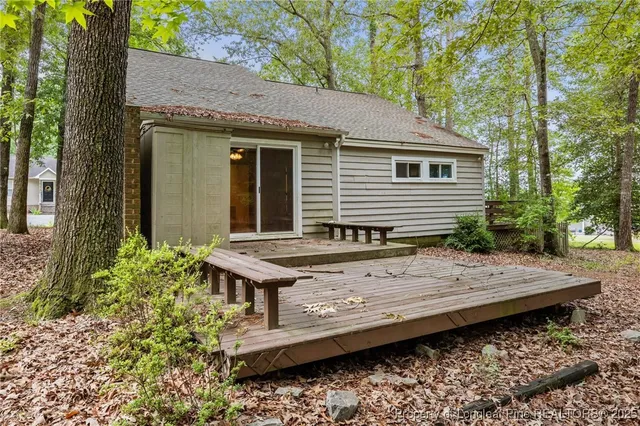 a view of a house with a wooden fence