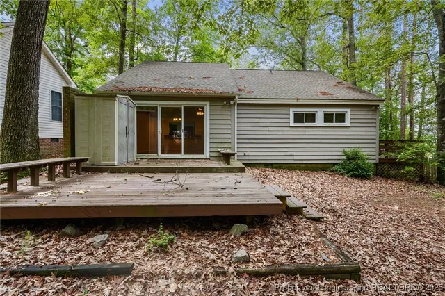 a view of a house with balcony and wooden floor