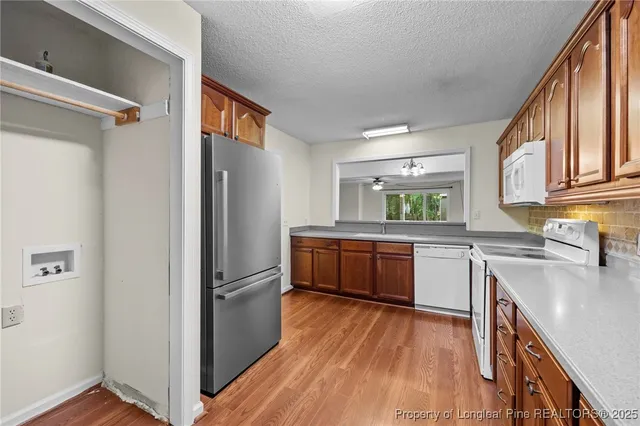 a kitchen with stainless steel appliances granite countertop a refrigerator a sink and dishwasher