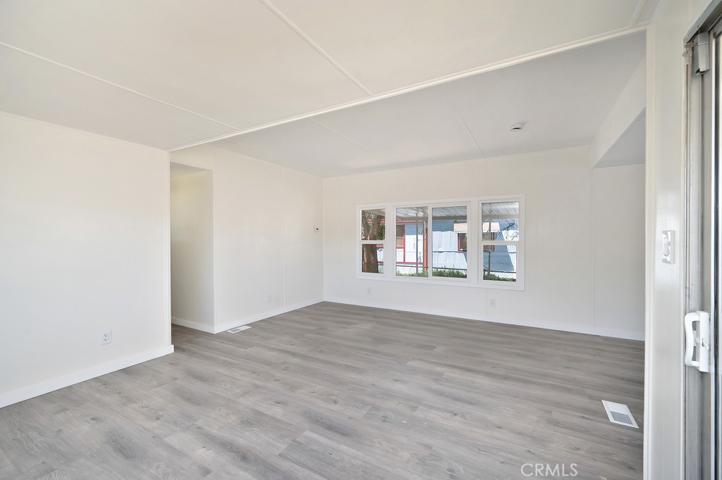 26455 Paradise Valley Road, Unit 86 Warner Springs, CA 92086 - Photo 18 of 34 an empty room with wooden floor and windows
