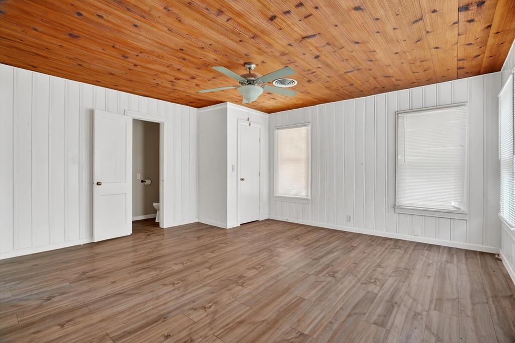 320 North 2nd Street Jacksboro, TX 76458 - Photo 9 of 16 a view of empty room with wooden floor and fan