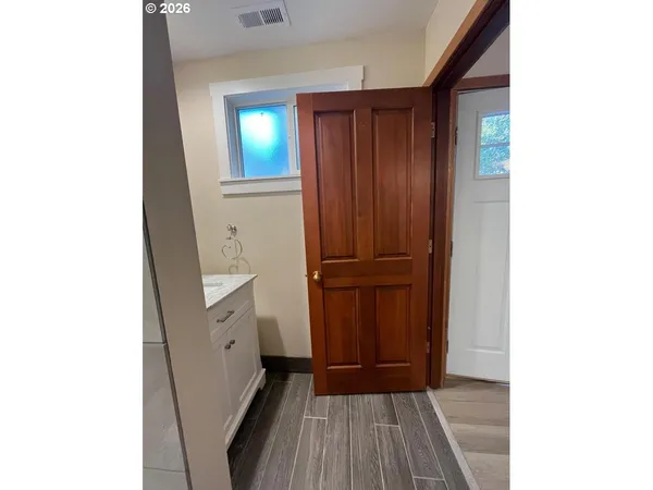 a view of a hallway with wooden floor