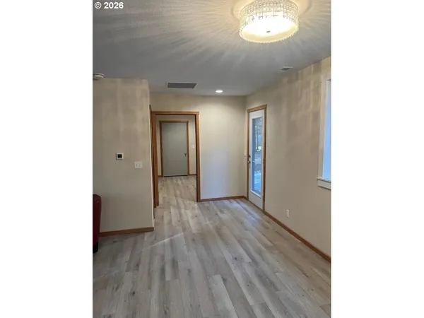 a view of a hallway with wooden floor