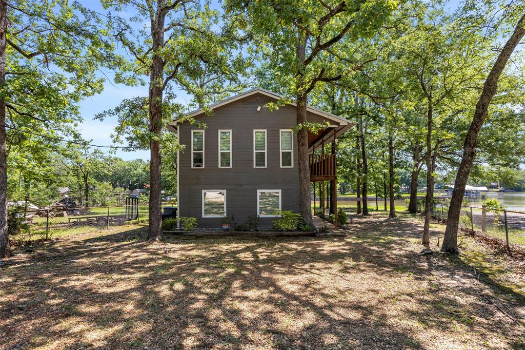 7110 Apache Circle Mabank, TX 75156 - Photo 6 of 39 Two-story residence featuring a gray exterior and multiple windows