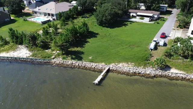 an aerial view of a house with yard