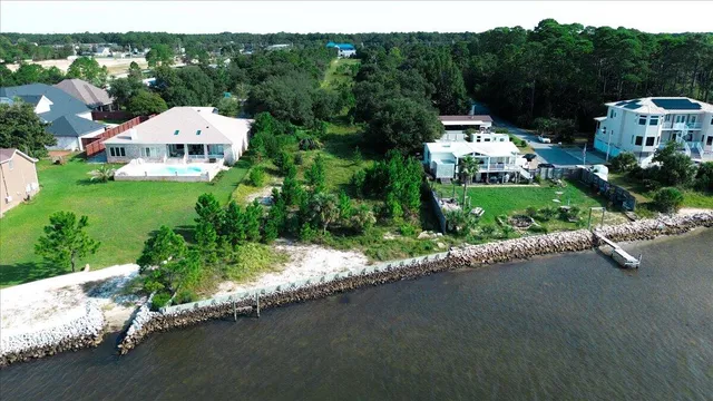 an aerial view of residential house with outdoor space and lake view