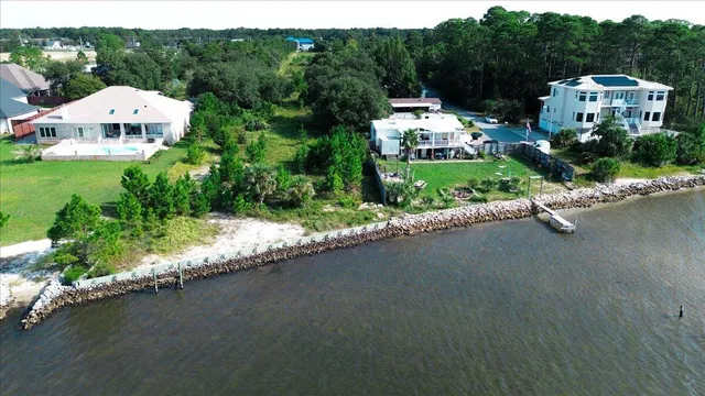 an aerial view of a house with a yard basket ball court and outdoor seating
