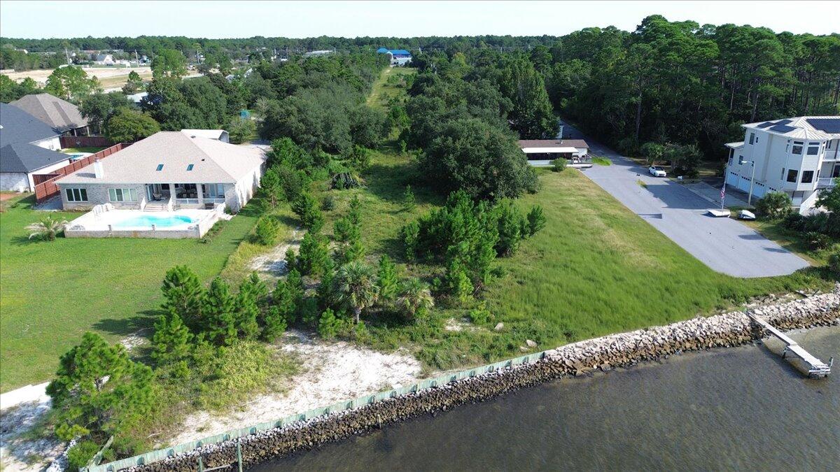 1907 Blankenship Road Navarre, FL 32566 - Photo 17 of 32 a view of a house with a garden and a pond