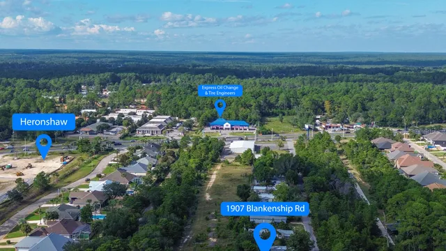 an aerial view of a house with a yard basket ball court and outdoor seating