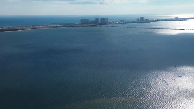 an aerial view of a house with a garden and lake view