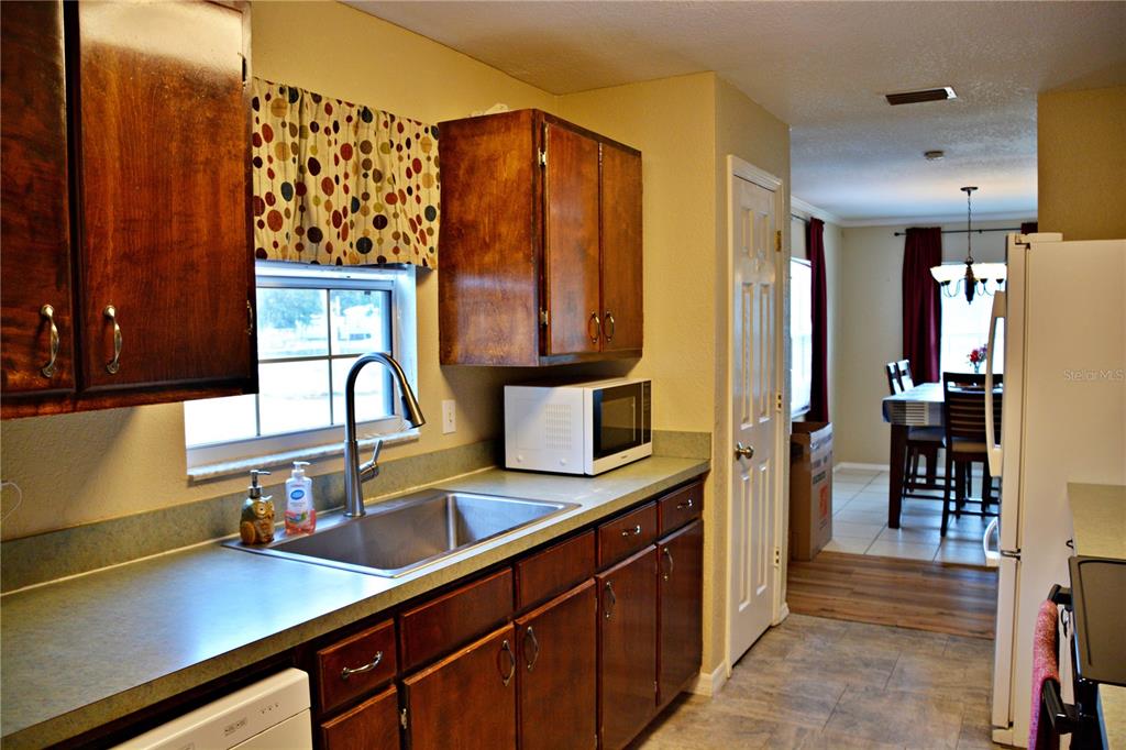 5528 Cherry Road Lakeland, FL 33810 - Photo 14 of 47 a kitchen with stainless steel appliances a sink stove and cabinets