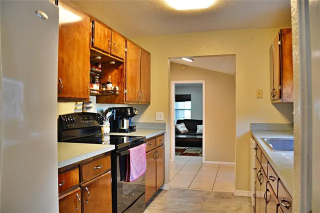 a kitchen with stainless steel appliances granite countertop a stove and a microwave