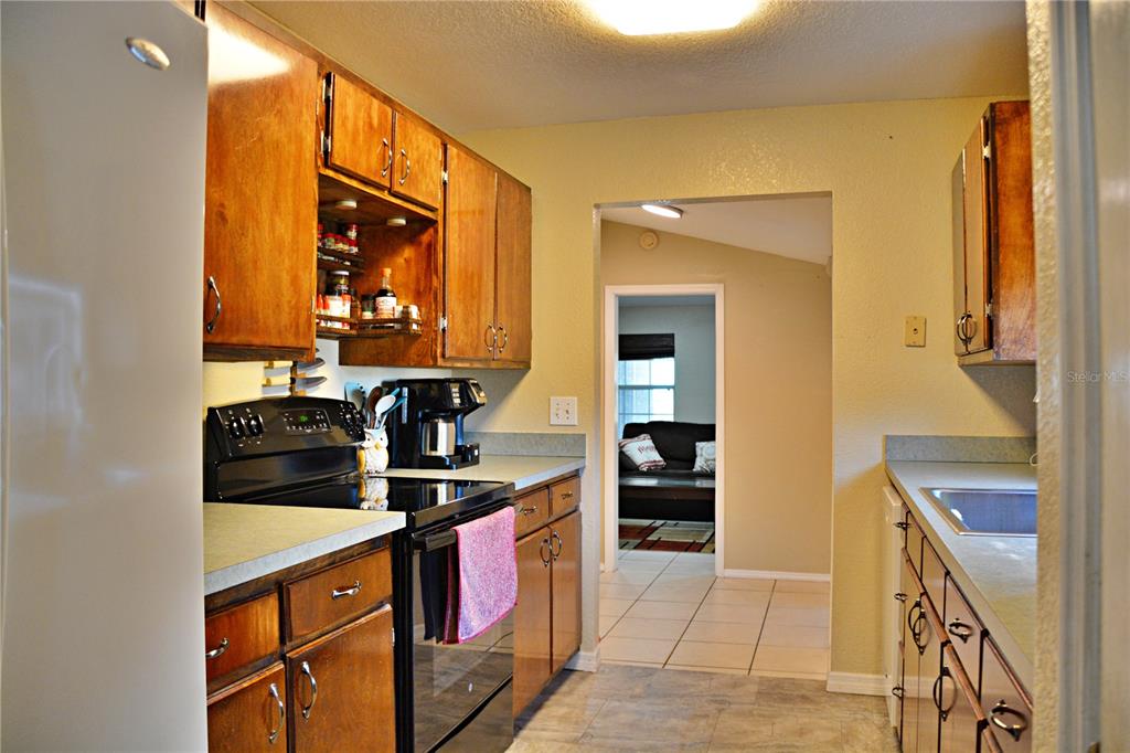 5528 Cherry Road Lakeland, FL 33810 - Photo 15 of 47 a kitchen with stainless steel appliances granite countertop a stove and a microwave