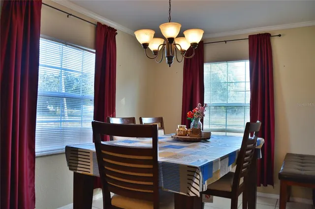 a view of a dining room with furniture and chandelier