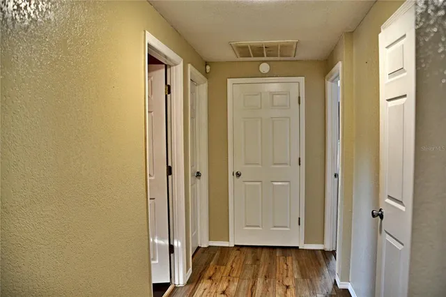 a view of front door with wooden floor