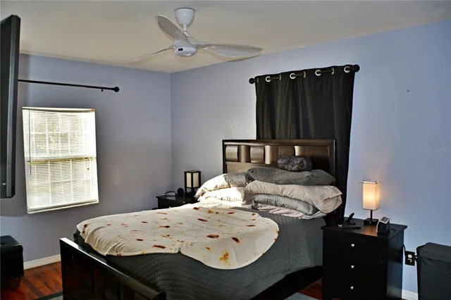 a bedroom with a bed and window