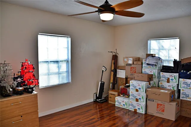 a view of a workspace with furniture and a window