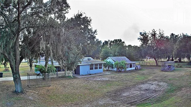 a view of house with trees in the background